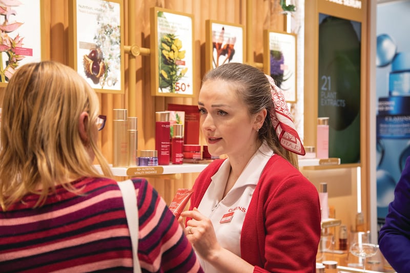 Beauty therapist Lilia Popovici speaks to customers about the product range at the Clarins boutique and spa on Wicklow Street, Dublin