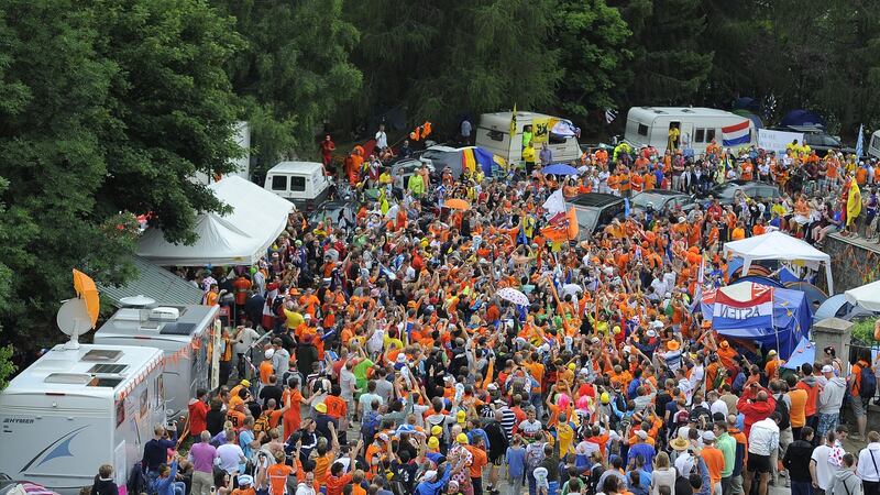 Spectators at  Dutch corner hold up traffic during stage 18 of the 2013 Tour on Alpe d’Huez. Photograph: Charlie Crowhurst/Getty Images