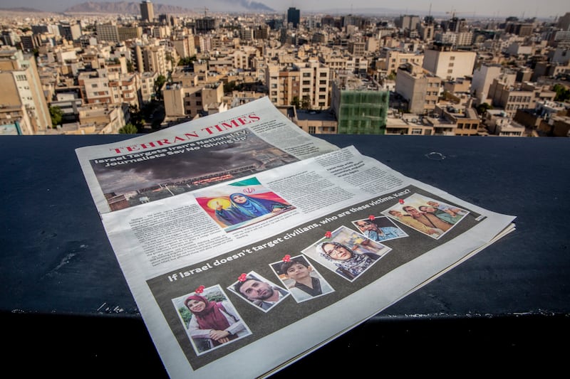 A copy of the Tehran Times newspaper showing people killed in recent Israeli strikes. Photograph: Arash Khamooshi/The New York Times
