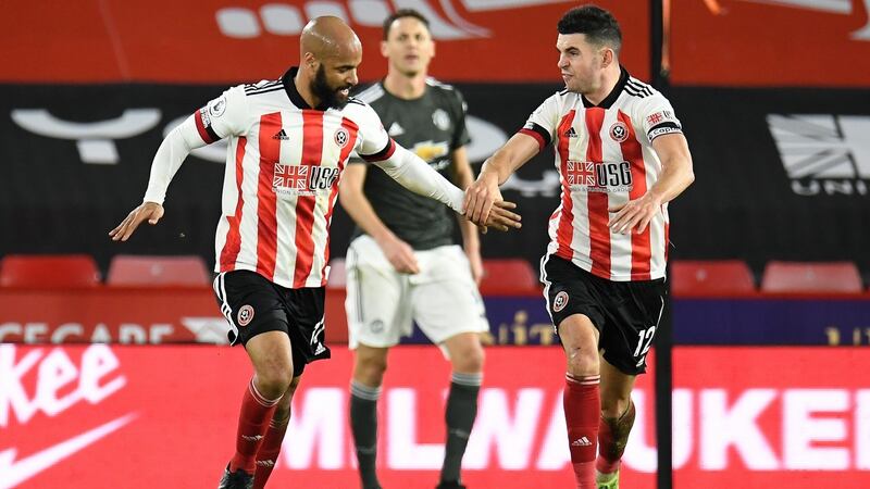 Sheffield United’s David McGoldrick is congratulated by team-mate  John Egan after scoring during the Premier League game against Manchester United at Bramall Lane. Photograph: Peter Powell/EPA
