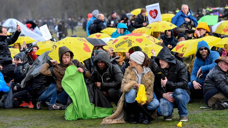 People gather under the rain during a demonstration against the government and anti-Covid-19 measures at Malieveld in The Hague. Photograph: Getty