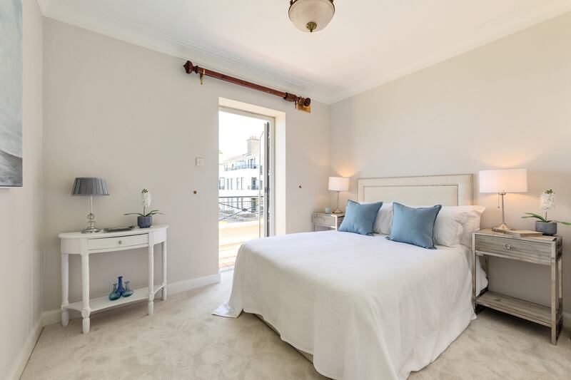 The property has three bedrooms, two of which have balconies