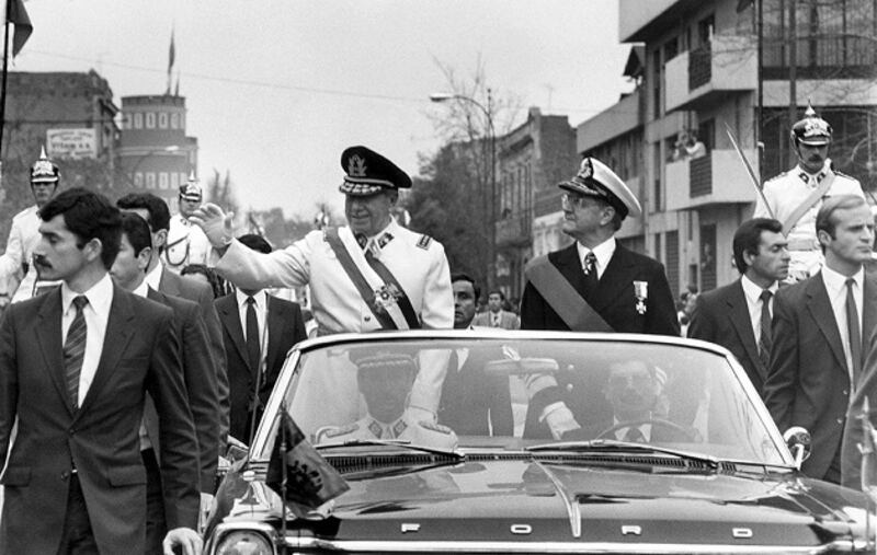 General Augusto Pinochet (l), head of the Chilean military junta, waves from the motorcade 11 September 1973 in Santiago, shortly after his coup that killed President Allende. Photograph: AFP/Getty Images