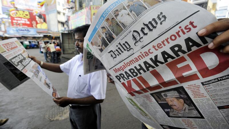 A man looks at a newspaper  that details the end of the near four-decades long ethnic conflict in Colombo in May 2009. Photograph: Ishara S Kodikara/AFP via Getty Images