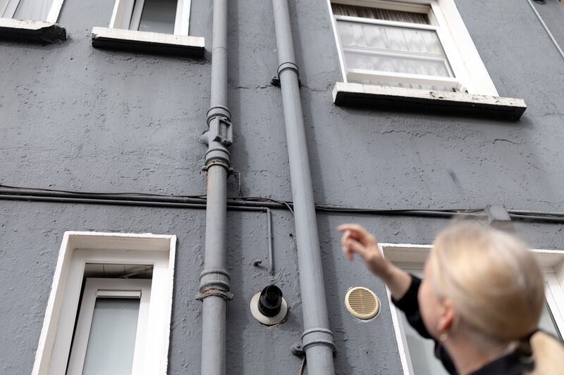 Lynsey McGrath, who lives in the Mercer House flat complex in Dublin, is experiencing mould and sewage leaking from an exterior drain pipe. Photograph: Chris Maddaloni