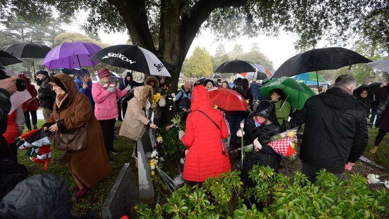 Visiting graves on a rain-drenched afternoon at  Glasnevin Cemetery during the eighth annual Flowers for Magdalenes memorial event. Photograph: Dara Mac Dónaill/The Irish Times