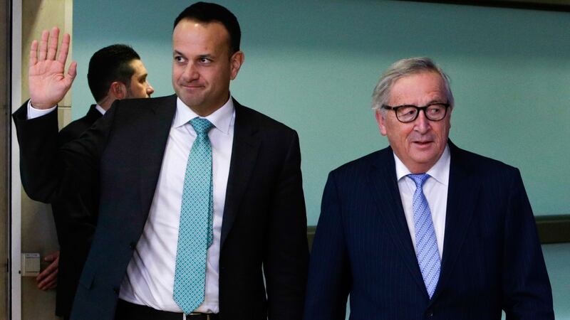 Taioseach Leo Varadkar  waves as he walks past European Commission president Jean-Claude Juncker at the European Commission headquarters in Brussels on February 6th. Photograph: Aris Oikonomou/AFP/Getty Images