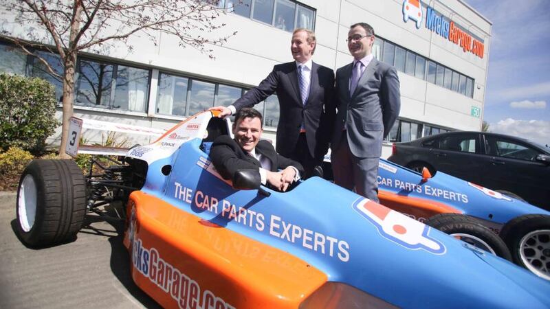 Taoiseach Enda Kenny with Ciaran and Michael Crean at the opening of MicksGarage.com headquarters in Park West, Dublin.  Their business began life in a bedroom in 2004. Now it’s an €11 million turnover company employing 48 people. Photograph: Conor McCabe Photography