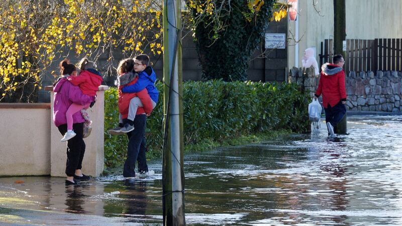 Local residents on  Manor Road in Mountmellick, where up to half a metre of water flooded into homes  on Wednesday. Photograph: Alan Betson/The Irish Times