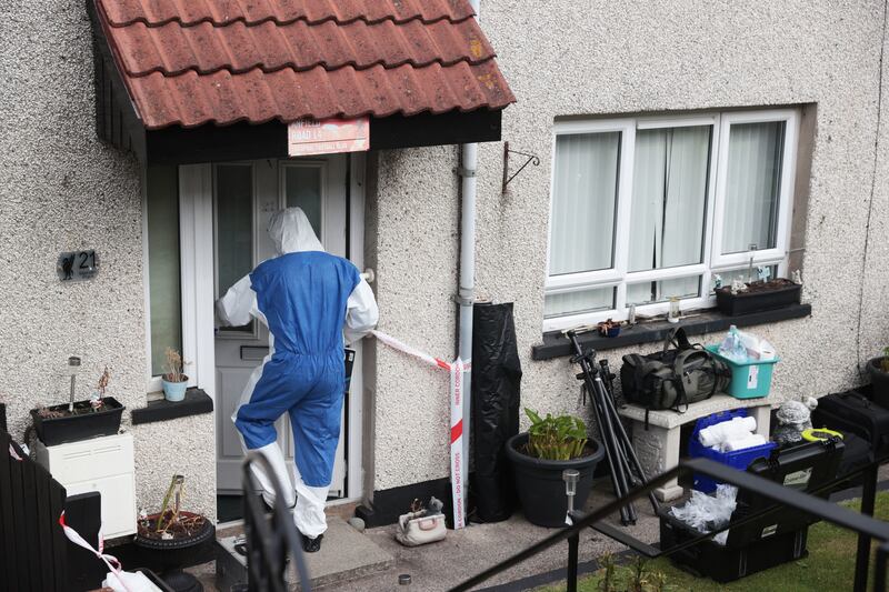 A Police Service of Northern Ireland officer at the scene in the Marian Park area of Downpatrick, Co Down, after a murder investigation was launched into a man's death that police said may be linked to an attack on a priest in a church in Co Down. Photograph: Liam McBurney/PA Wire