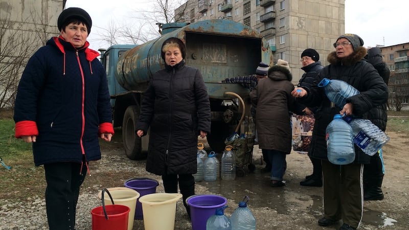 Valya Burakova (in spectacles, on right) and her neighbours collect water from a tanker in Toretsk, eastern Ukraine, where the water supply was cut by shelling on November 22nd. Photograph: Daniel McLaughlin