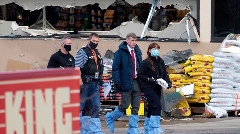 Crime scene investigators walk outside the entrance of the King Soopers grocery store in Boulder, Colorado. Photograph: Jason Connolly/AFP  via Getty