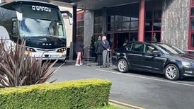 Woman escorted into mandatory quarantine hotel after refusing to leave bus