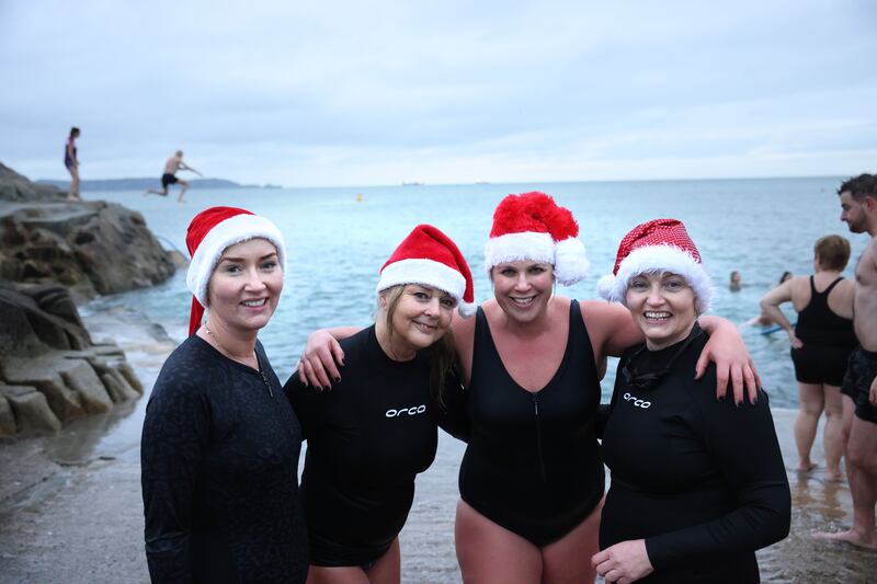 Ruth Murray, Karen Federston, Jenny Caffrey and Emer Gleeson, from Knocklyon, at Christmas Day swim at the Forty Foot, Sandycove, Dublin. Photograph: Dara Mac Dónaill / The Irish Times








