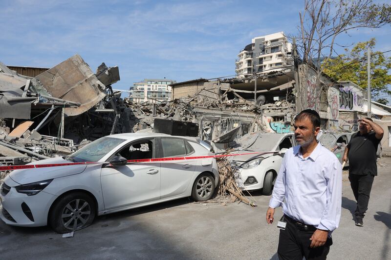 Residents view destroyed vehicles and structures in Tel Aviv Sunday, following overnight Hamas rocket attacks. Photograph: Abir Sultan/EPA
