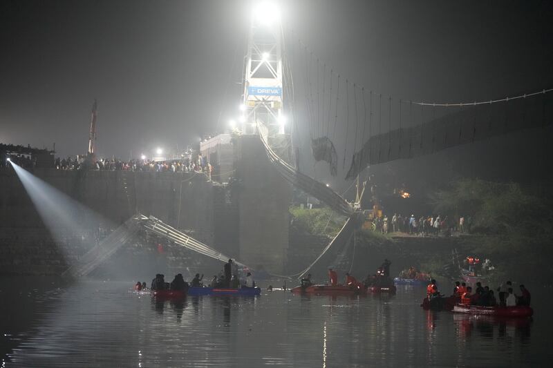 Rescuers on boats search for survivors in the Machchu river.  Photograph: Ajit Solanki/AP