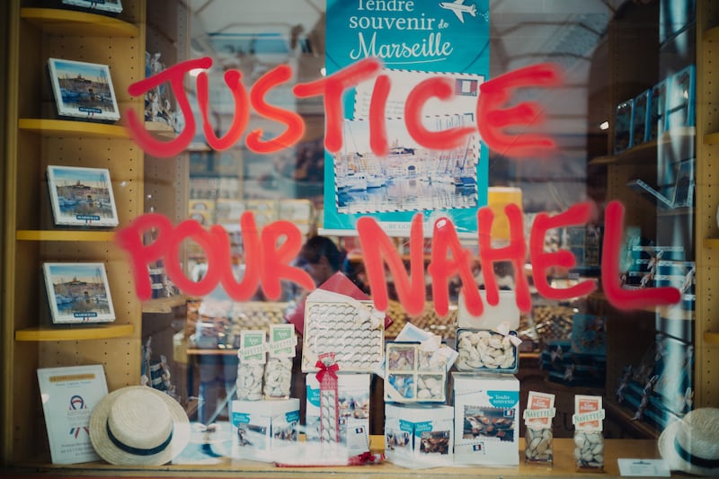 A shop window vandalised with spray paint reading 'Justice for Nahel' after a night of clashes, in the center of Marseille, France. Photograph: Orianne Ciantar/EPA