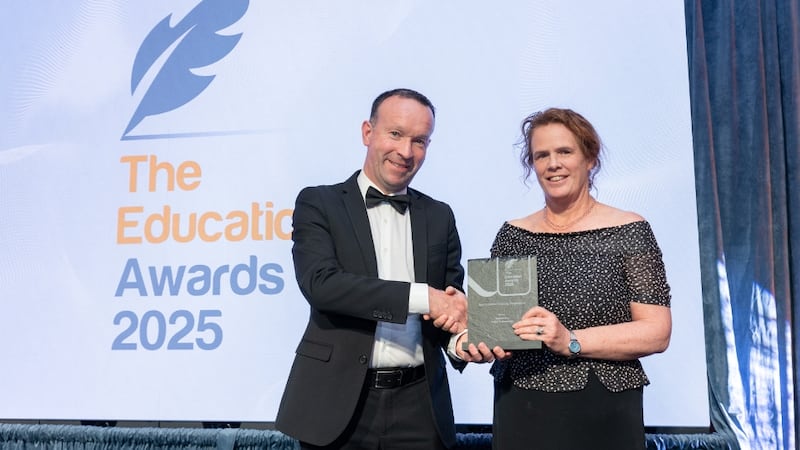 Liam O'Reilly, awards judge, presents the best graduate training programme to Sinead Kelly, William Fry