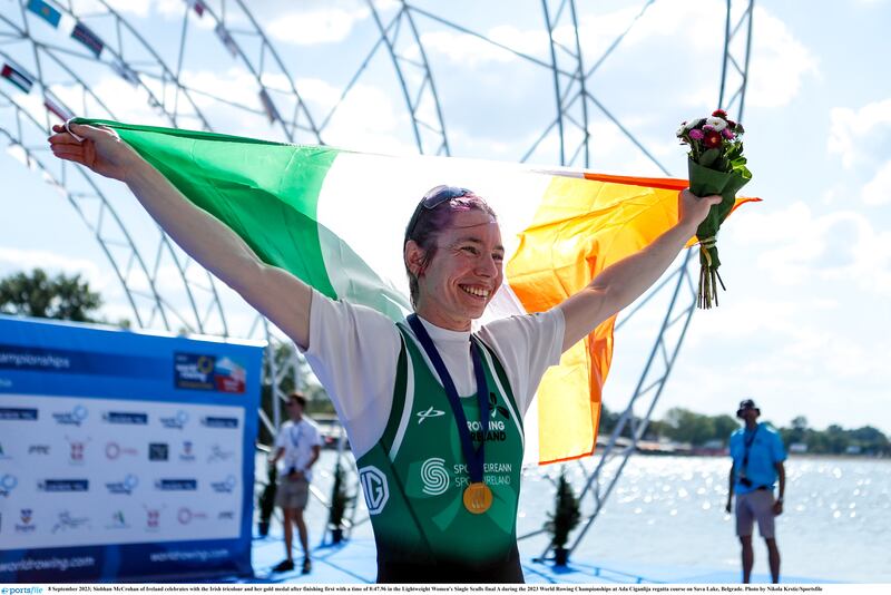Siobhan McCrohan celebrates with the Irish tricolour and her gold medal after finishing first with a time of 8:47.96 in the Lightweight Women's Single Sculls final A during the 2023 World Rowing Championships. Photograph: Nikola Krstic/Sportsfile