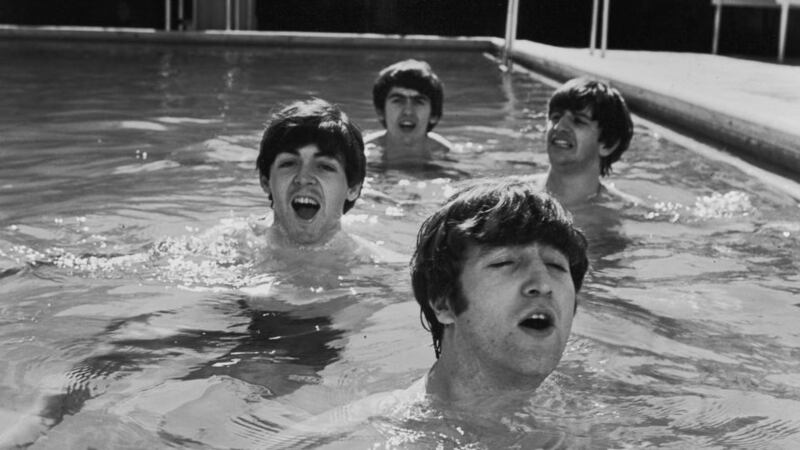 (L-R) Beatles Paul McCartney, George Harrison, John Lennon and Ringo Starr take a dip in a swimming pool. Photograph: John Loengard//Time Life Pictures/Getty Images 