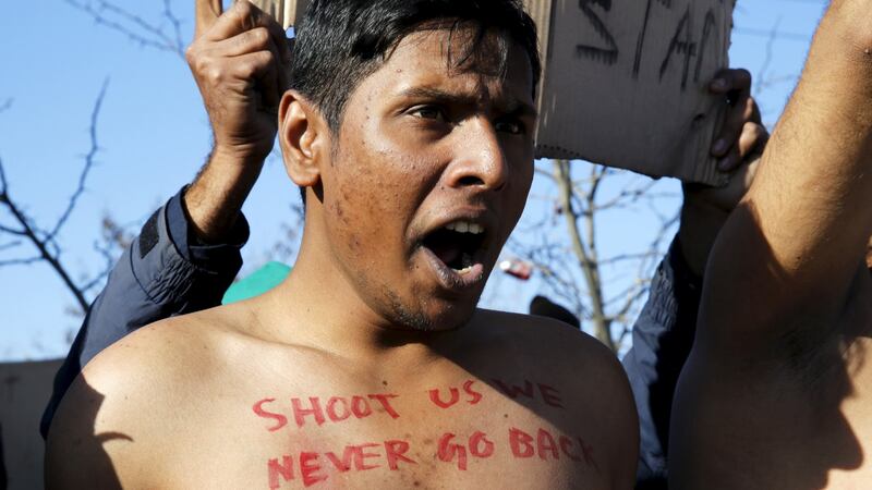 A Bangladeshi migrant protests at the border between Greece and Macedonia: The men had written slogans on their chests in red paint. “Shoot us, we never go back,” read one. “Shoot us or save us,” read another. Photograph: Yannis Behrakis/Reuters