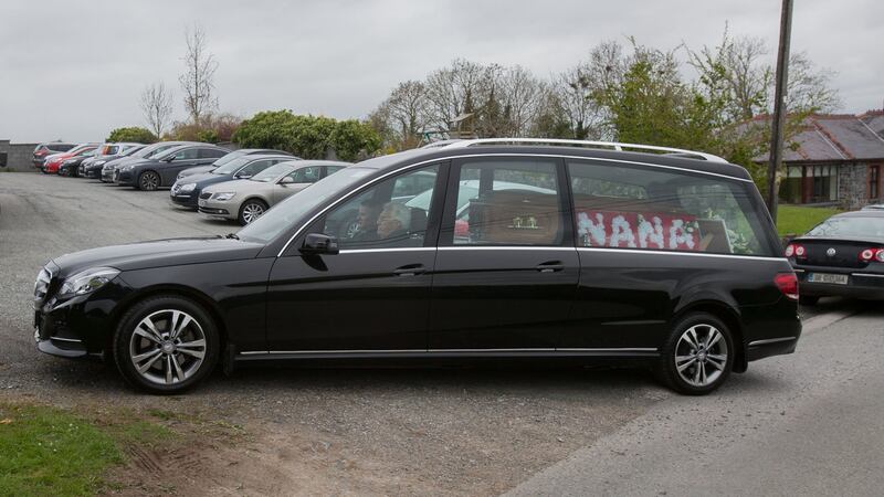 The hearse arrives at the Church of the Holy Cross before her funeral. Photograph:  Gareth Chaney/Collins