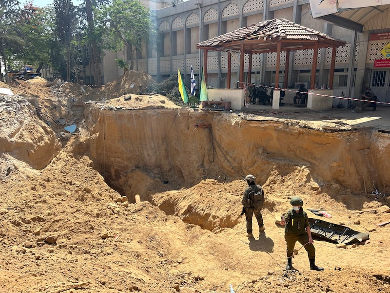 Israeli soldiers stand in a hole used to gain access to the tunnel underneath the hospital. Photograph: Patrick Kingsley/New York Times