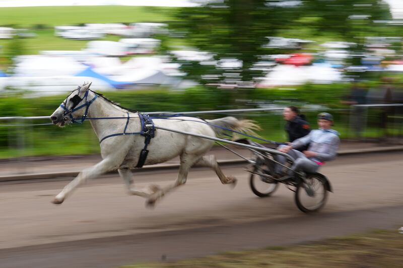 People racing in a horse-drawn carriage during the Appleby Horse Fair. Photograph: Owen Humphreys/PA