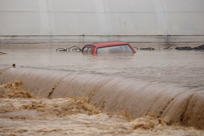 A submerged car amid flowing floodwaters in Kiseljak. Photograph: Armin Durgut/AP