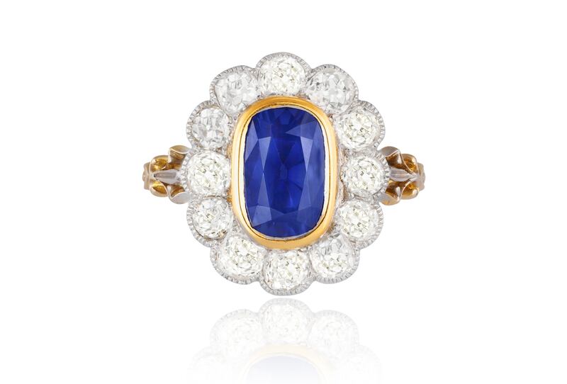 Kashmir sapphire ring in the centre of a cluster of diamonds, Adam's