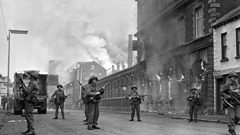 British soldiers armed with machine guns keeping watch in the Falls Road during rioting, August 1969. Photograph: Popperfoto via Getty