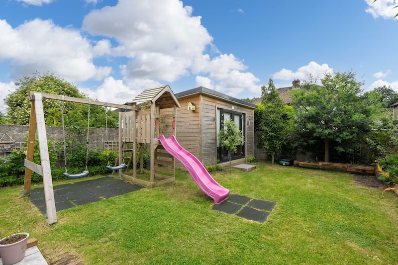 A garden room lies to the rear