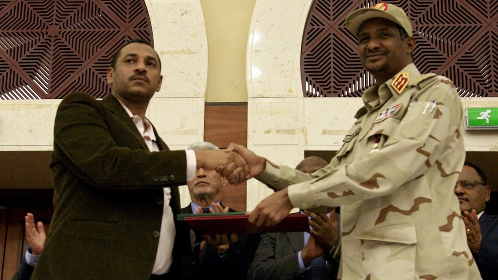 Sudanese deputy chief of the ruling miliary council Mohamed Hamdan Dagalo (R) and protest movement Alliance for Freedom and Changes leader Ahmad al-Rabiah shake hands after signing an agreement before African Union and Ethiopian mediators in Khartoum early on July 17th, 2019. Photograph: Ebrahim Hamid/AFP/Getty Images