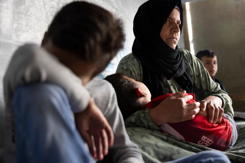 Khawla Kobbieh takes care of her seven children as her husband is out looking for work. They left Syria when all the houses around them in their village had been destroyed. 'The whole village left in cars,' she says. 'We didn’t bring anything but our clothes.' They are now living in an informal tented settlement in Saadnayel, in Lebanon’s Bekaa valley. Photograph: Chris Maddaloni


