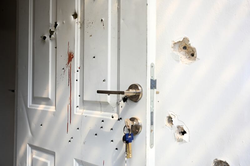 Gunshots and blood stains on a door and walls of a house where civilians were killed in an attack by Hamas militants on a kibbutz in Kfar Aza, Israel, near the border with Gaza. Photograph: Alexi J Rosenfeld/Getty Images
