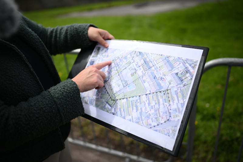 Dr Niamh McCullagh, senior forensic officer, with a map of the dig site. Photograph: Charles McQuillan/Getty