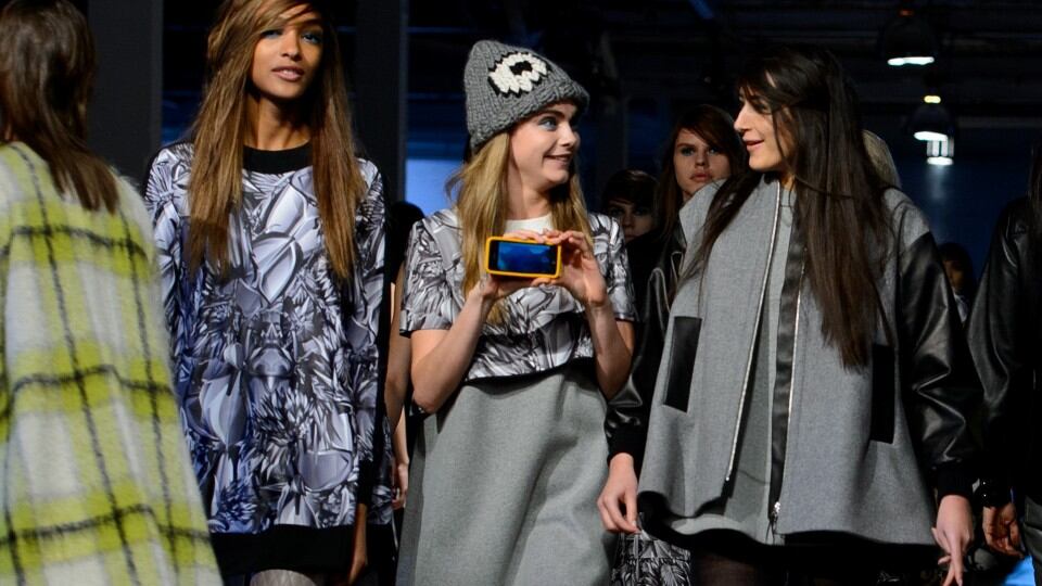 Cara Delevingne films herself backstage at Giles. Photograph: Getty Images