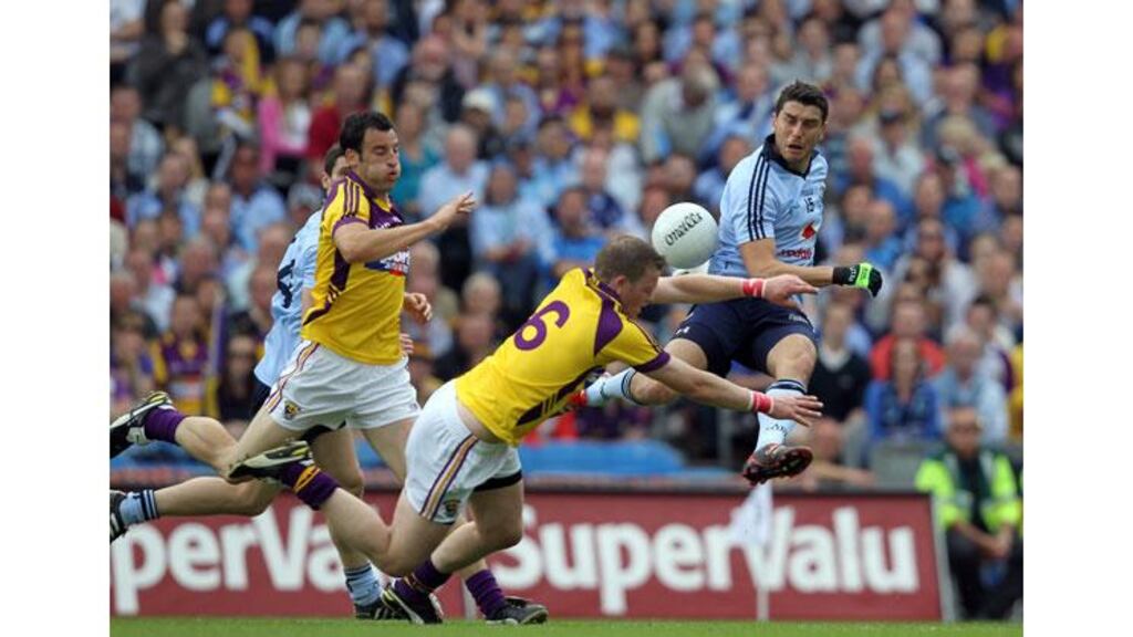 Bernard Brogan has a shot charged down by Wexford captain David Murphy during the 2011 Leinster SFC final at Croke Park. - (Photograph: Colm O'Neill/Inpho)