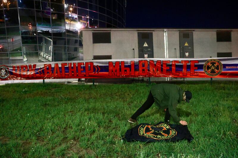 A man pays tribute to Yevgeny Prigozhin at the makeshift memorial in front of the PMC Wagner Centre in St Petersburg. Photograph: AFP/Gettu