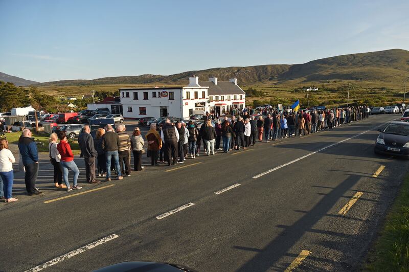 Mourners, including a number of Ukrainian war refugees, gather to offer condolences to the family and friends of Finbar Cafferkey on Achill on May 12th. Photograph: Conor McKeown
