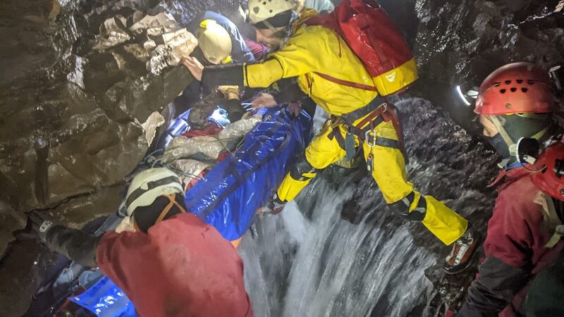 The injured man is carried by rescuers through the cave. Paul Taylor, SMWCRT spokesman, said it was the longest cave rescue ever undertaken in Wales. Photograph: South & Mid Wales Cave Rescue Team/PA Wire