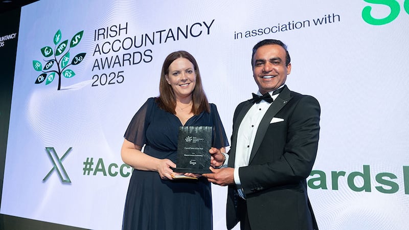 Paula Egan, head of sales UKI, Sage, presents the payroll team of the year award to Irfan Hameed, Beacon Locum Contracting