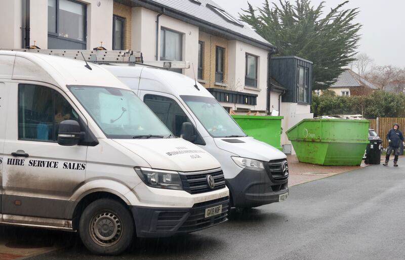 Work vans and skips outside the Cookstown Lane housing estate where all the houses were badly damaged by flooding during Storm Chandra