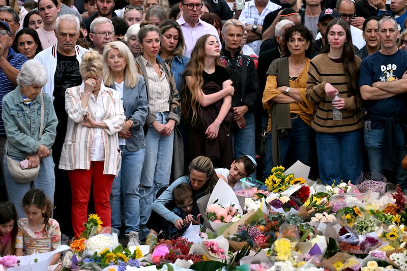 Family members of victims and other mourners near tributes at the Bondi Pavilion on Wednesday. Photograph: Saeed Khan/AFP/Getty Images