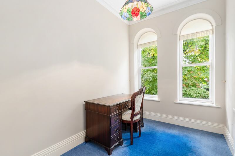 A bedroom currently in use as a study/home office