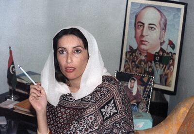 Pakistani People's Party leader Benazir Bhutto holds a press conference in front of a poster of her father (executed prime minister Zulfikar Ali Bhutto) at her home in Larkana as she won first parliamentary elections in 1988.