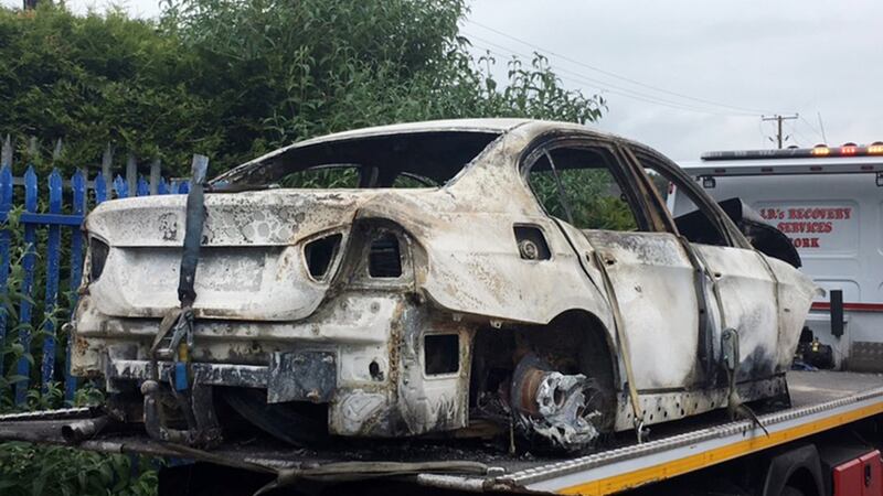 The burned-out car from which gardaí recovered a firearm in Waterfall, Co Cork. Photograph: Daragh McSweeney/Provision