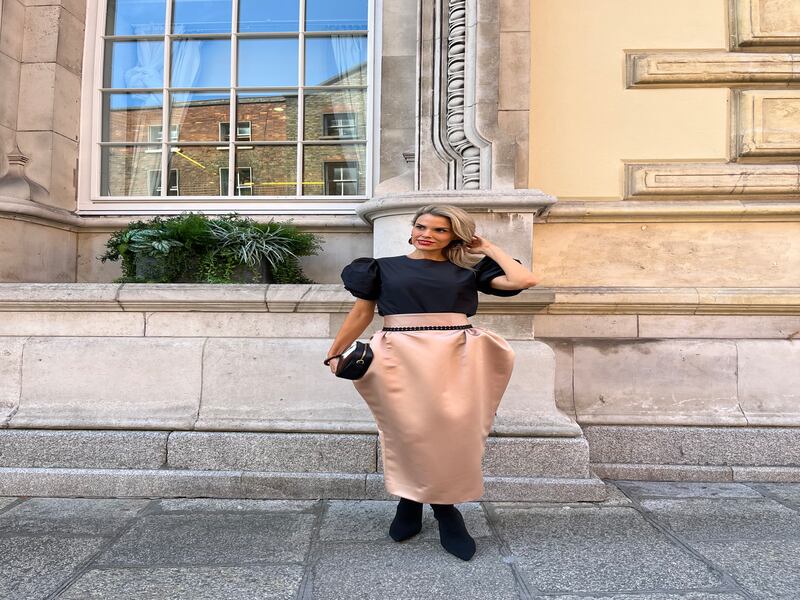 Black Cresswell taffeta puff sleeve top €465, coffee duchesse satin skirt with high waist and black braid detail €550