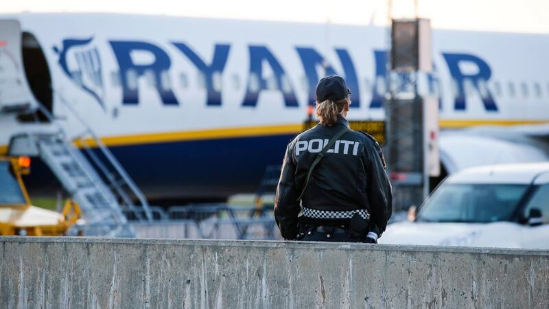 A police officer stands guard near a Ryanair plane on Rygge Airport in Moss, near Oslo, on Sunday where a police bomb squad was deployed to check the plane. The plane was scheduled to fly to Manchester, England. Photograph: EPA