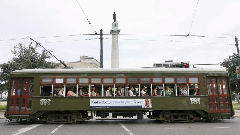 A streetcar passes by  a monument to Confederate General Robert E Lee at a traffic circle in New Orleans, Louisiana. Photograph: Jonathan Bachman/Reuters
